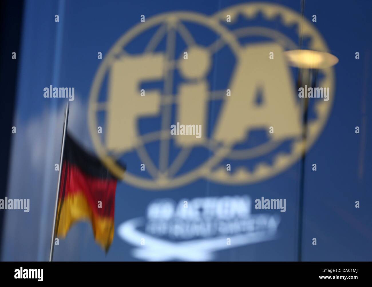 The German flag is reflected in the glass door of the FIA motorhome at the Nuerburgring circuit in Nuerburg, Germany, 07 July 2013. Photo: Jens Buettner/dpa Stock Photo