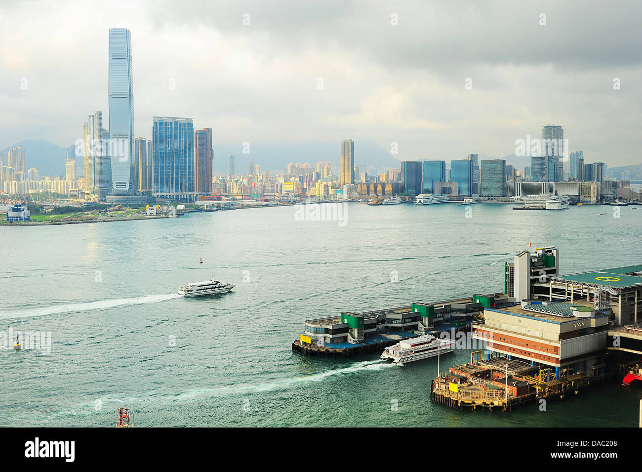 Kowloon island at sunset. Ferry pier from Hong Kong to Macao on the right. Stock Photo