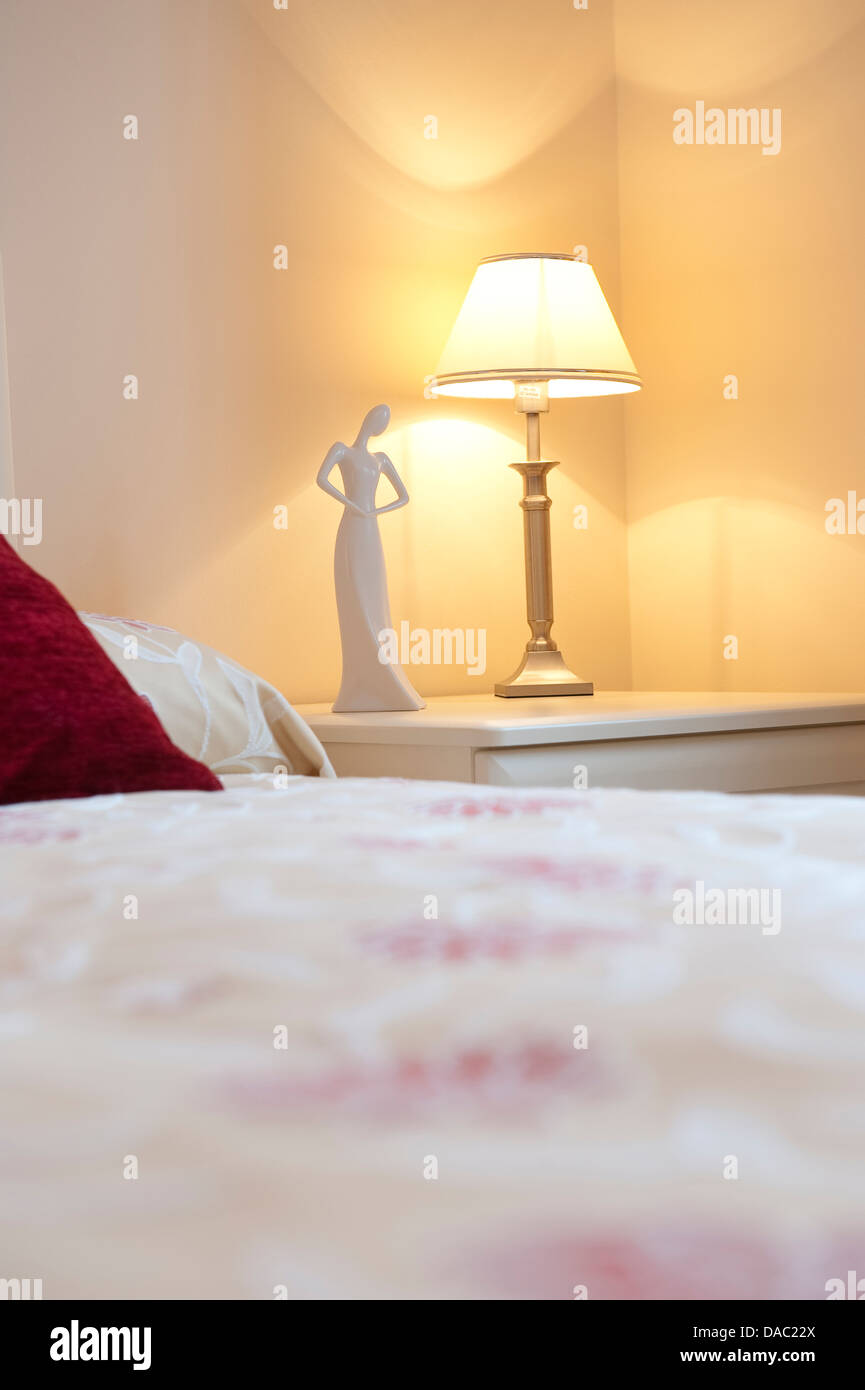 Lamp and ornament on a bedside table. Stock Photo