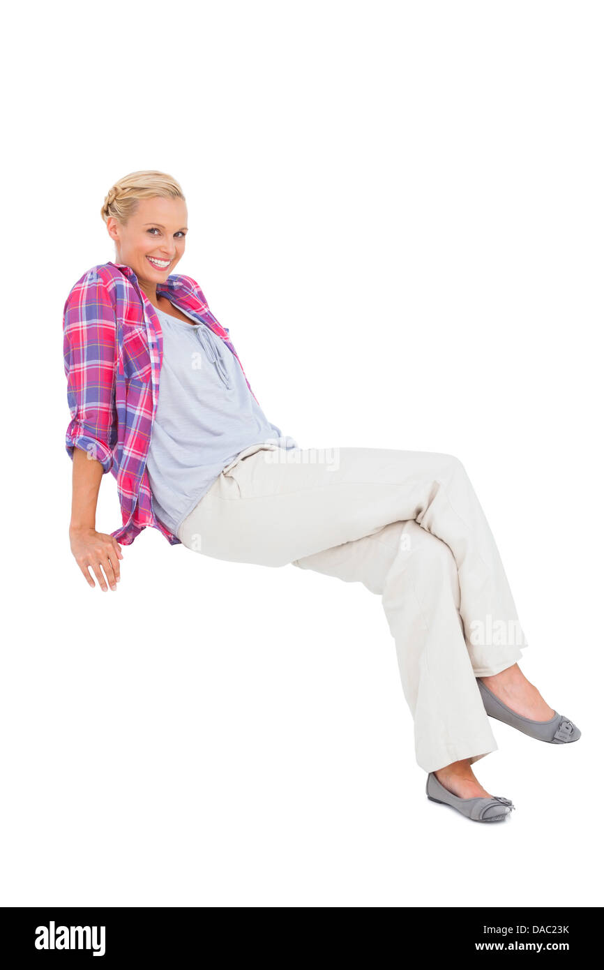 Smiling blonde sitting and looking at camera Stock Photo - Alamy