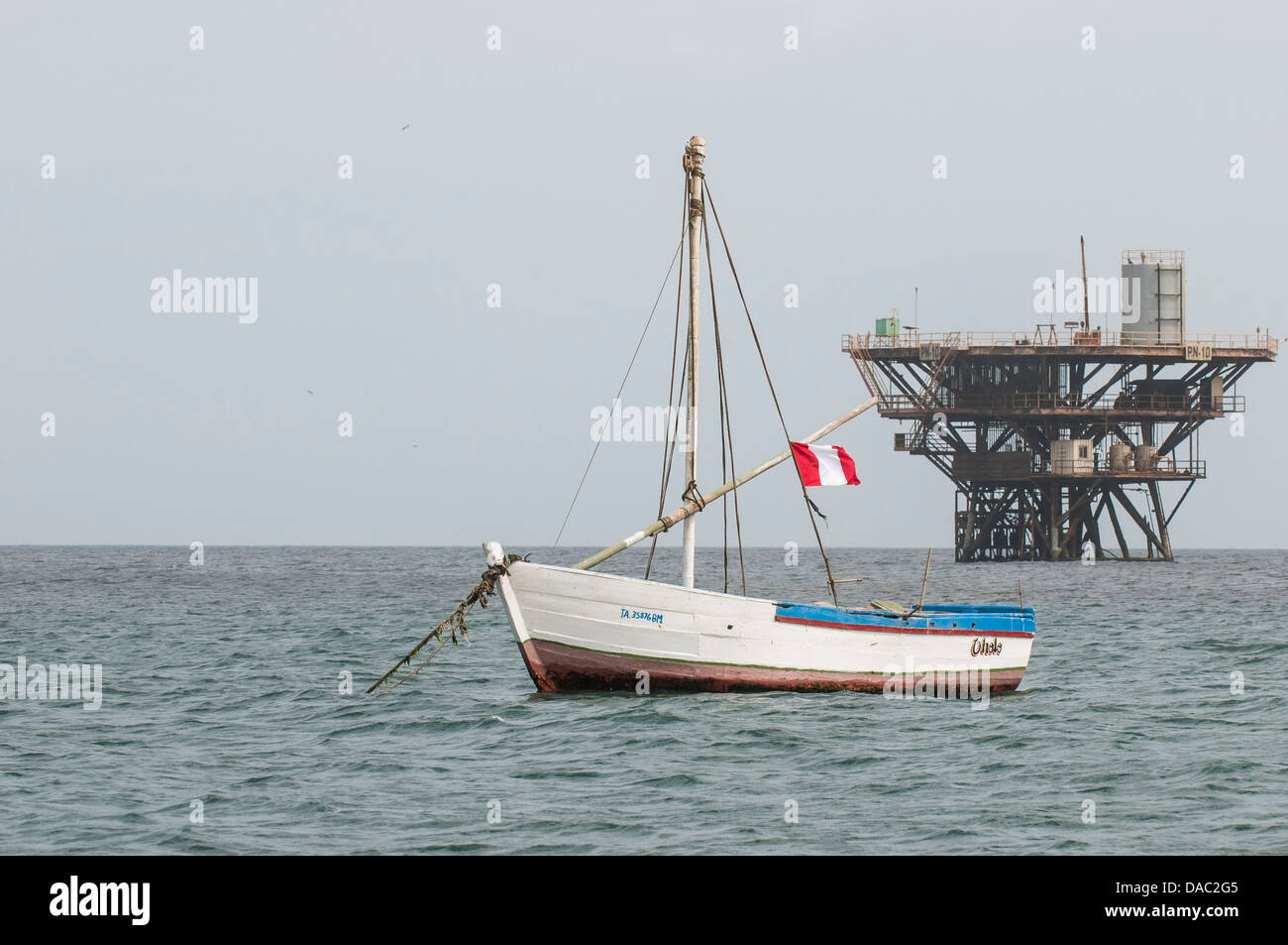 Fishing boats and offshore marine oil well platform off Cabo Blanco, Peru. Stock Photo