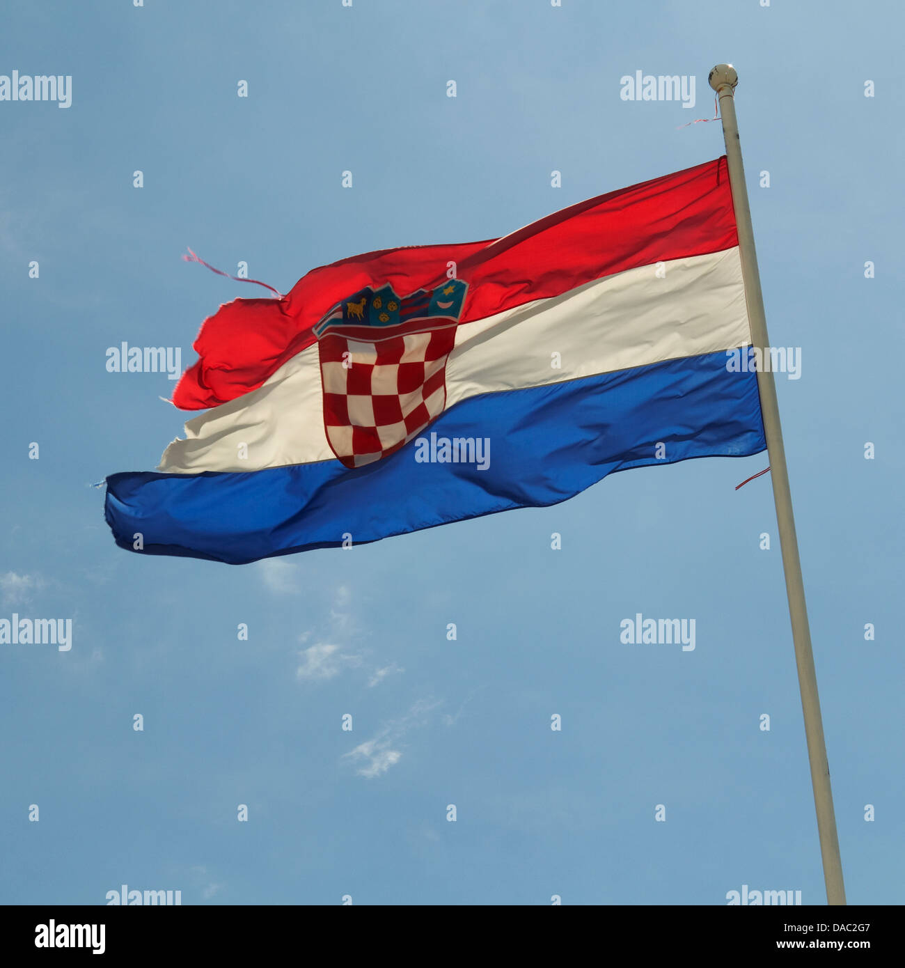 Croatia national flag flying on a flagpole against a blue sky Stock Photo