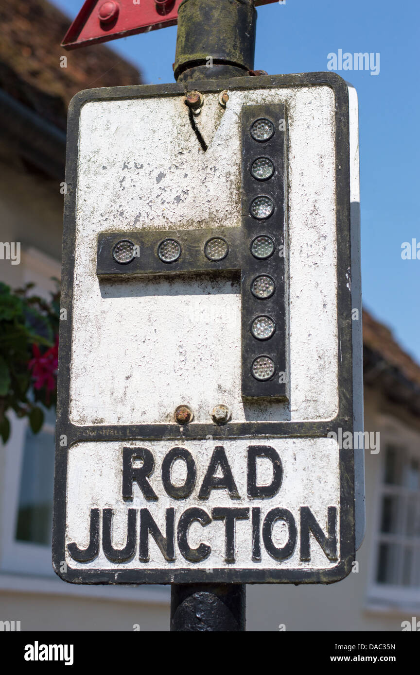 An old road junction signpost, with inset reflective disks. Stock Photo