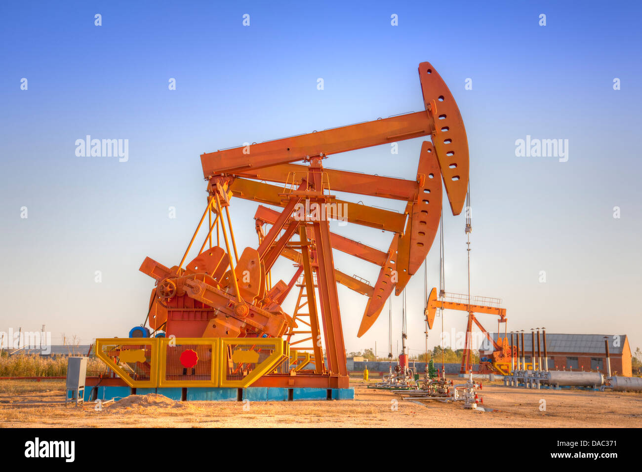 Huge steel oil pump jacks. (HDR Stock Photo Alamy