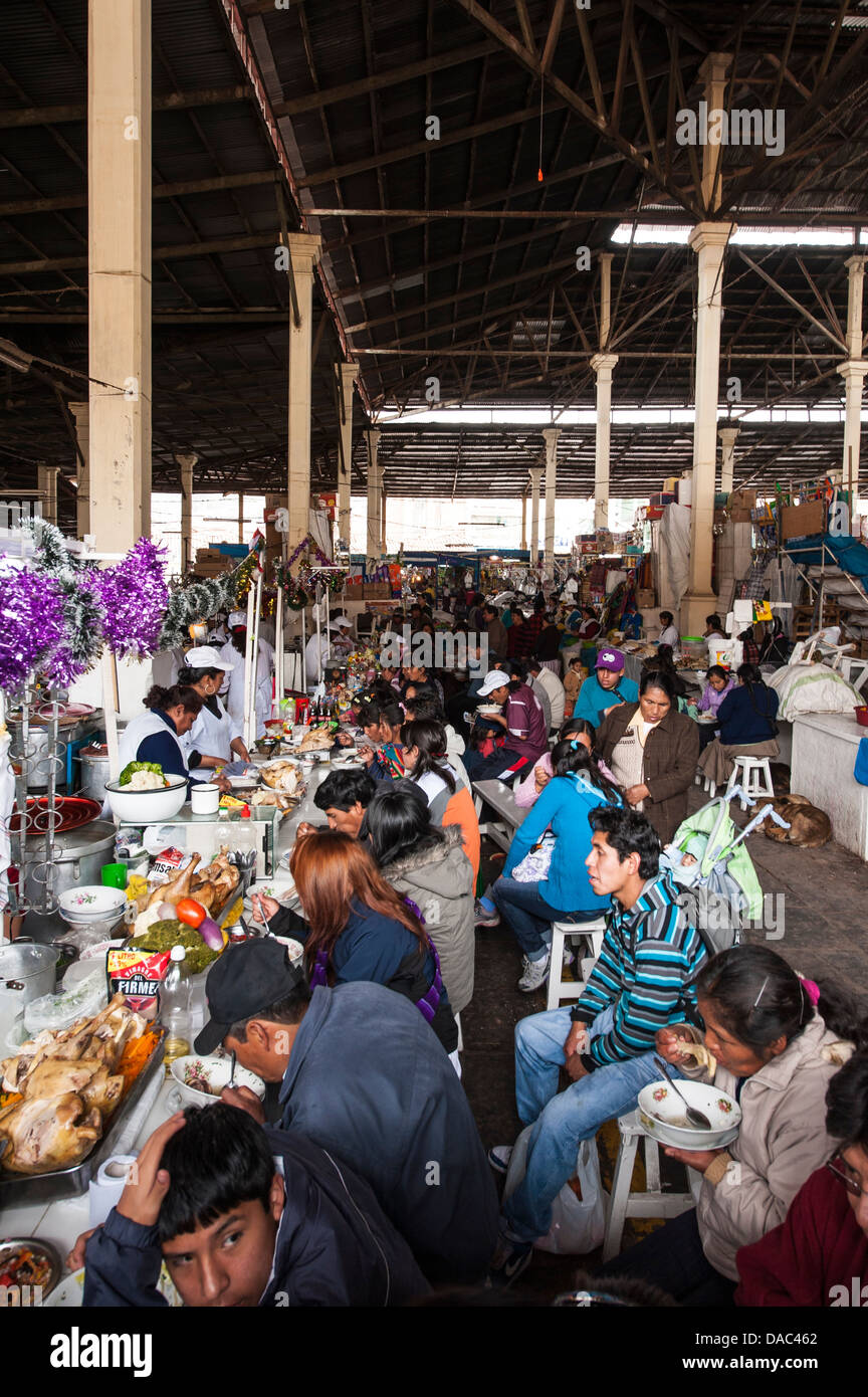 People eating at the central local covered produce market downtown Cusco, Peru. Stock Photo