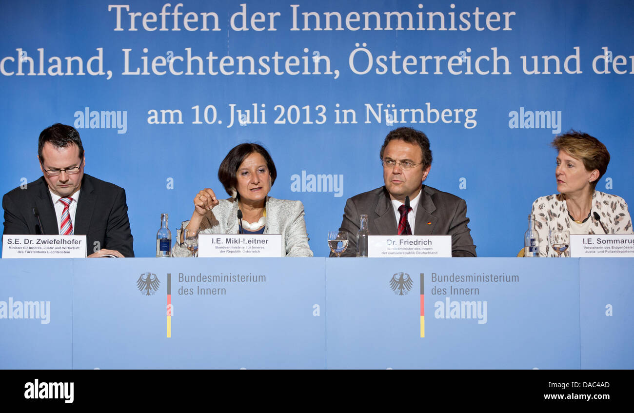 (L-R) Thomas Zwiefelhofer (VU), minister for interior affairs, justice, and economy of Liechtenstein, Austrian interior minister Johanna Mikl-Leitner (OeVP), German interior minister Hans-Peter Friedrich (CSU), Simonetta Sommaruga (SP), head of the Swiss justice and police department (EJPD), answer questions of journalists at a press conference of a meeting of interior ministers from German speaking countries in Nuremberg, Germany, 10 July 2013. The ministers want to talk about human trafficking, immigration, and integration as well as the situation of the Syrian refugees at the meeting. Photo Stock Photo