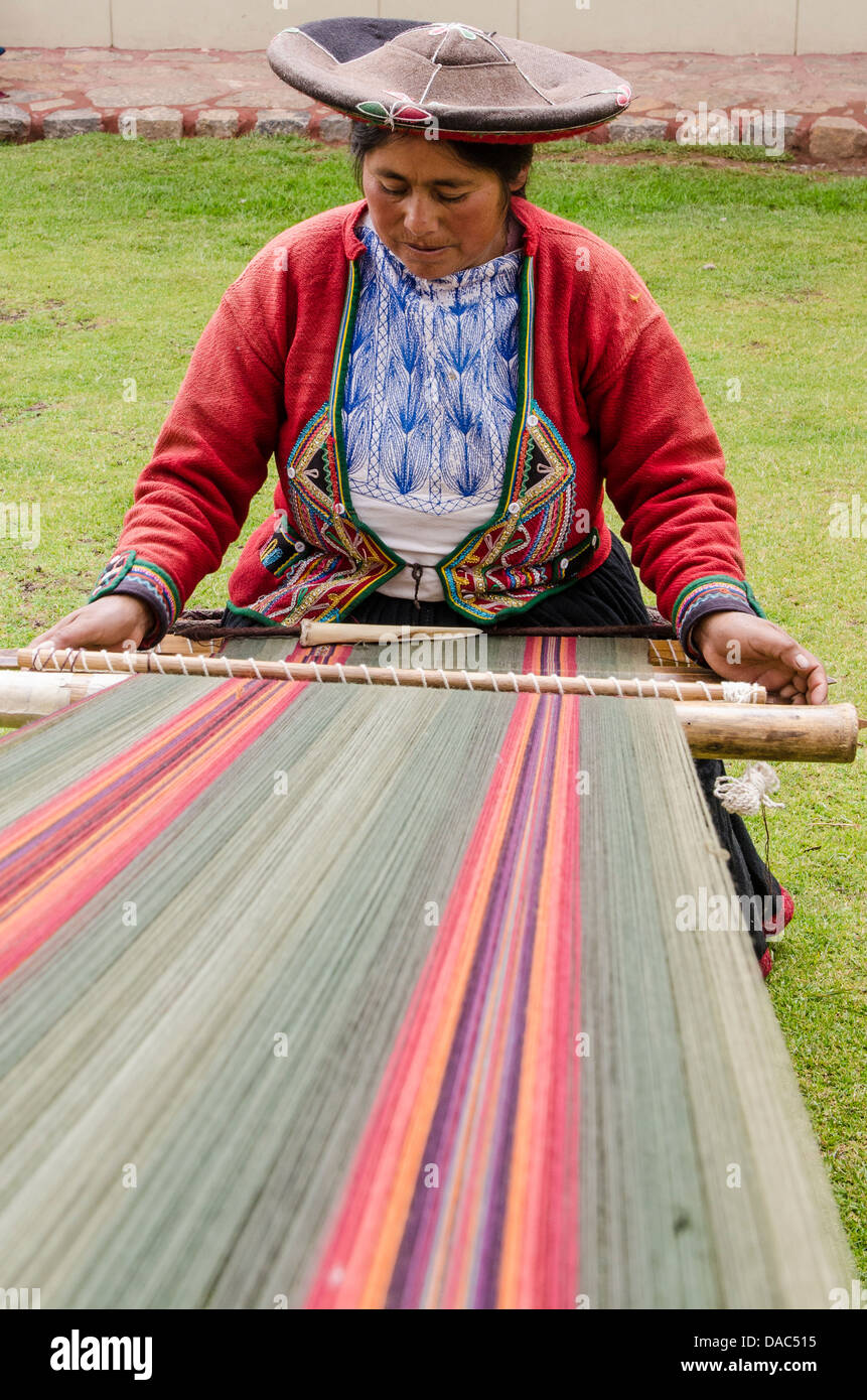 Traditionally red dress costume clothing sweater Inca woman weaver weaving  wool textile blanket backstrap loom Chinchero, Peru Stock Photo - Alamy