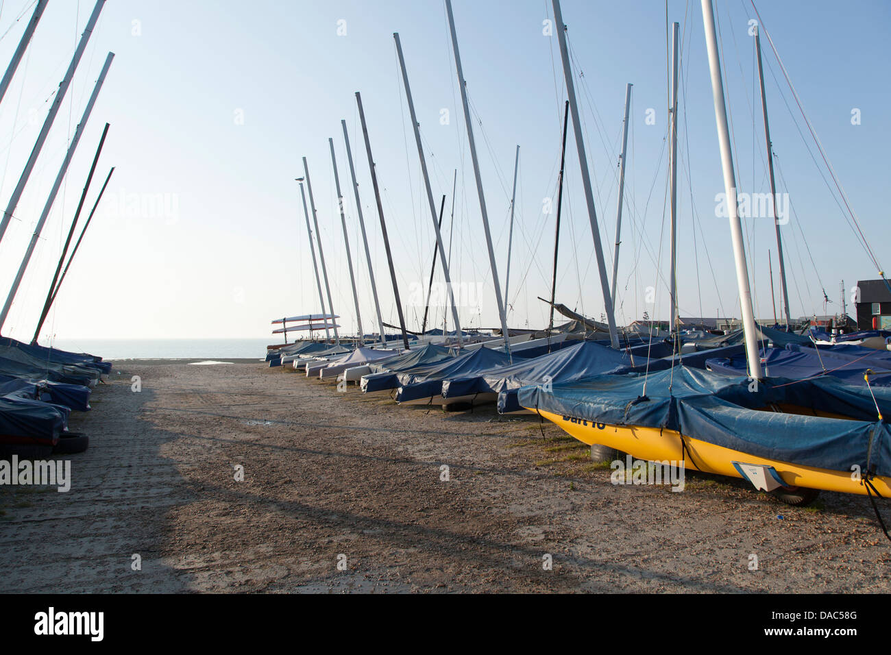 sail mast, ship masts, sea background, sunset, boats in foreground, sunshine and seaside, Whitstable, pathway, Stock Photo