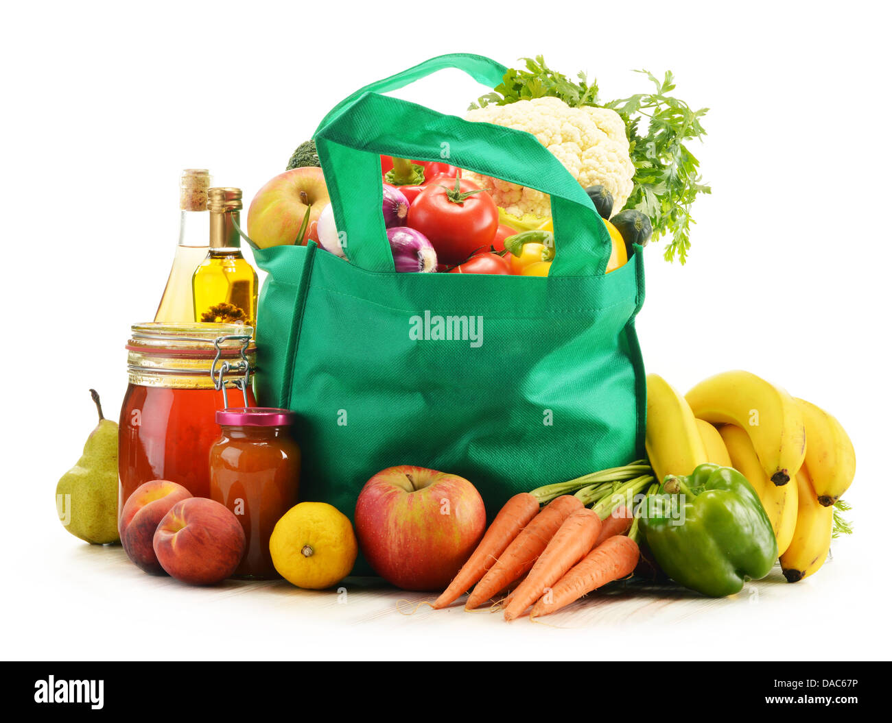 Green shopping bag with grocery products on white background Stock