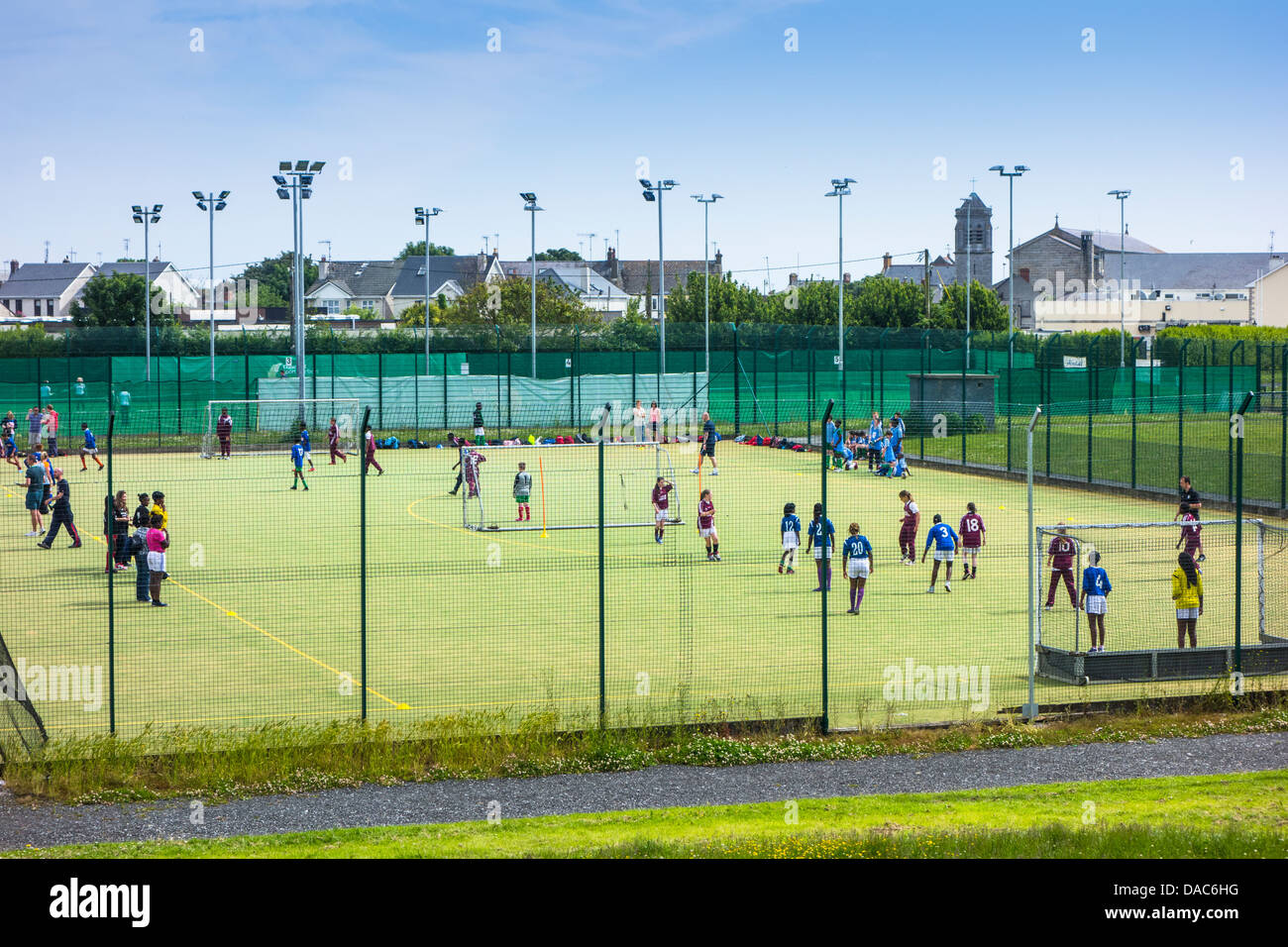 Schoolchildren playing football on an all-weather pitch - Dublin, Ireland Stock Photo