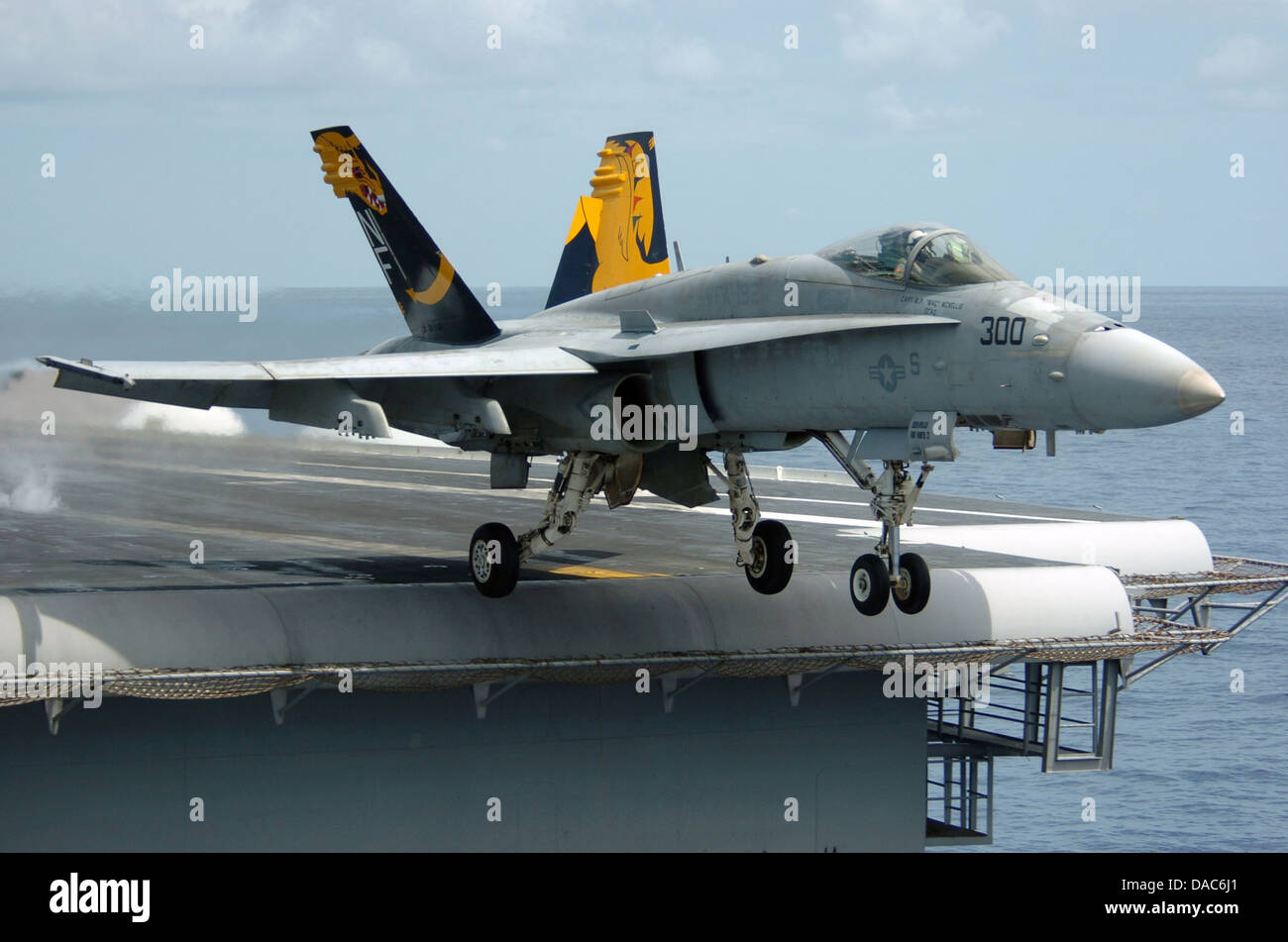 An F-A-18C Hornet launches from the flight deck of the conventionally powered aircraft carrier Stock Photo