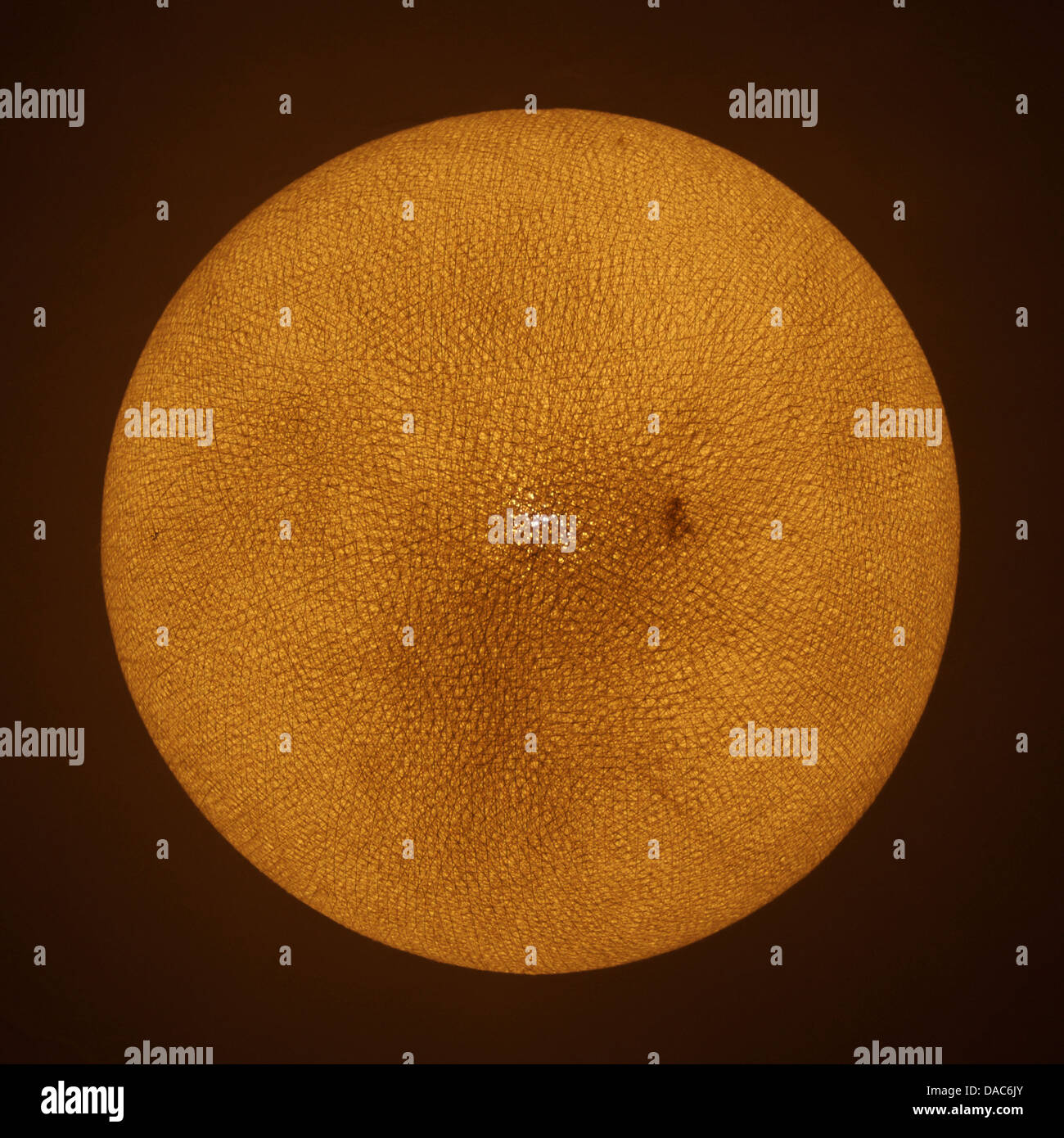 Glowing lampshade resembling the sun or other star Stock Photo