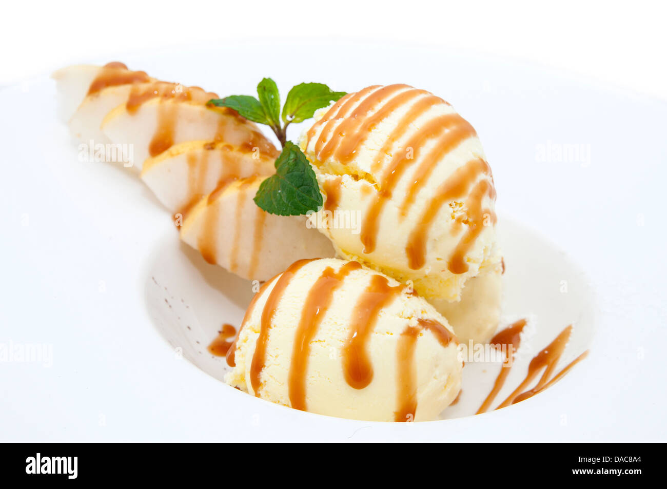 ice cream with caramel sauce and mint on a white background Stock Photo ...