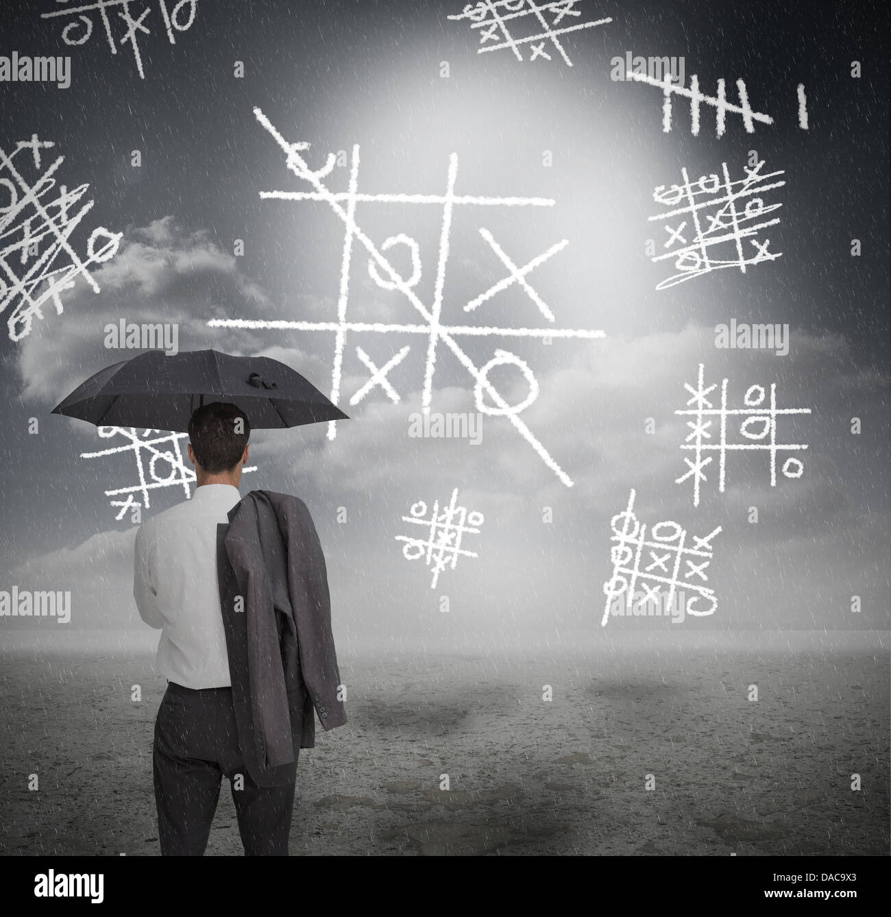 Businessman looking at noughts and crosses Stock Photo