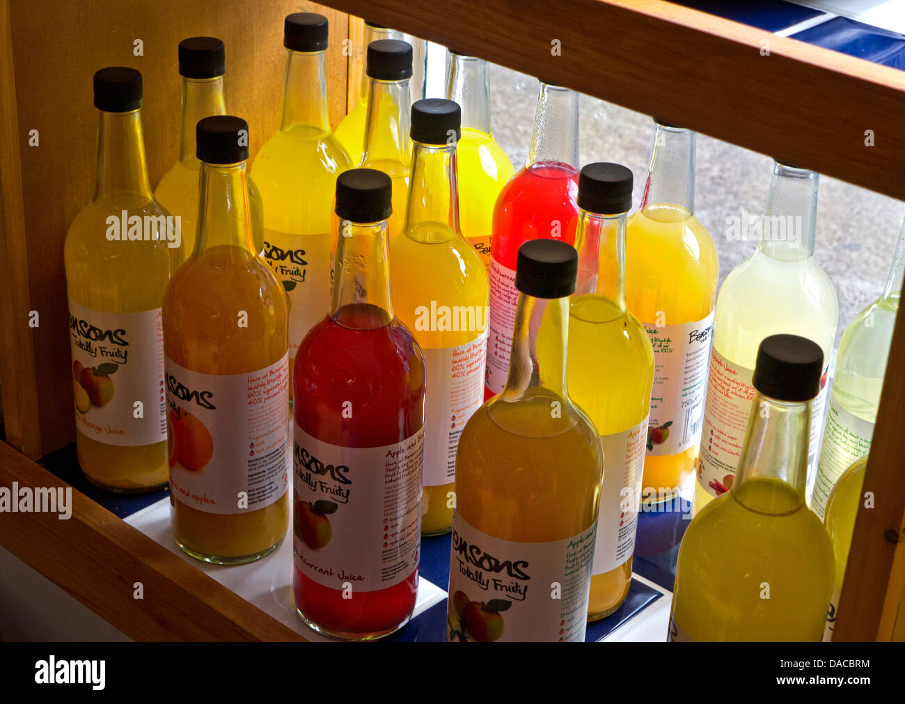 Variety of healthy bottled fruit juices on display for sale in