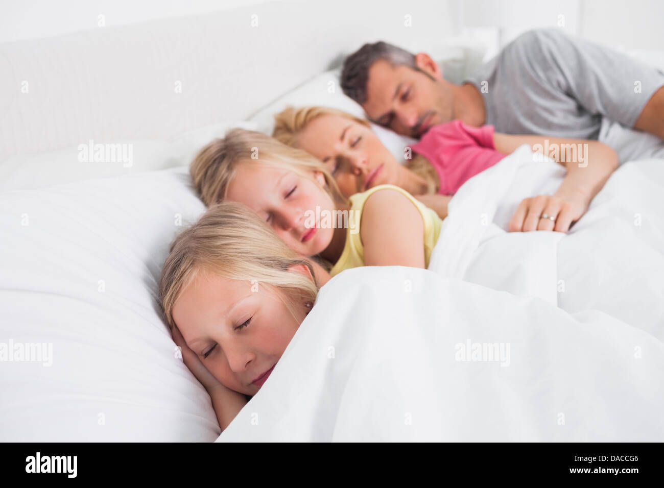 Parents sleeping with their children in bed Stock Photo Alamy