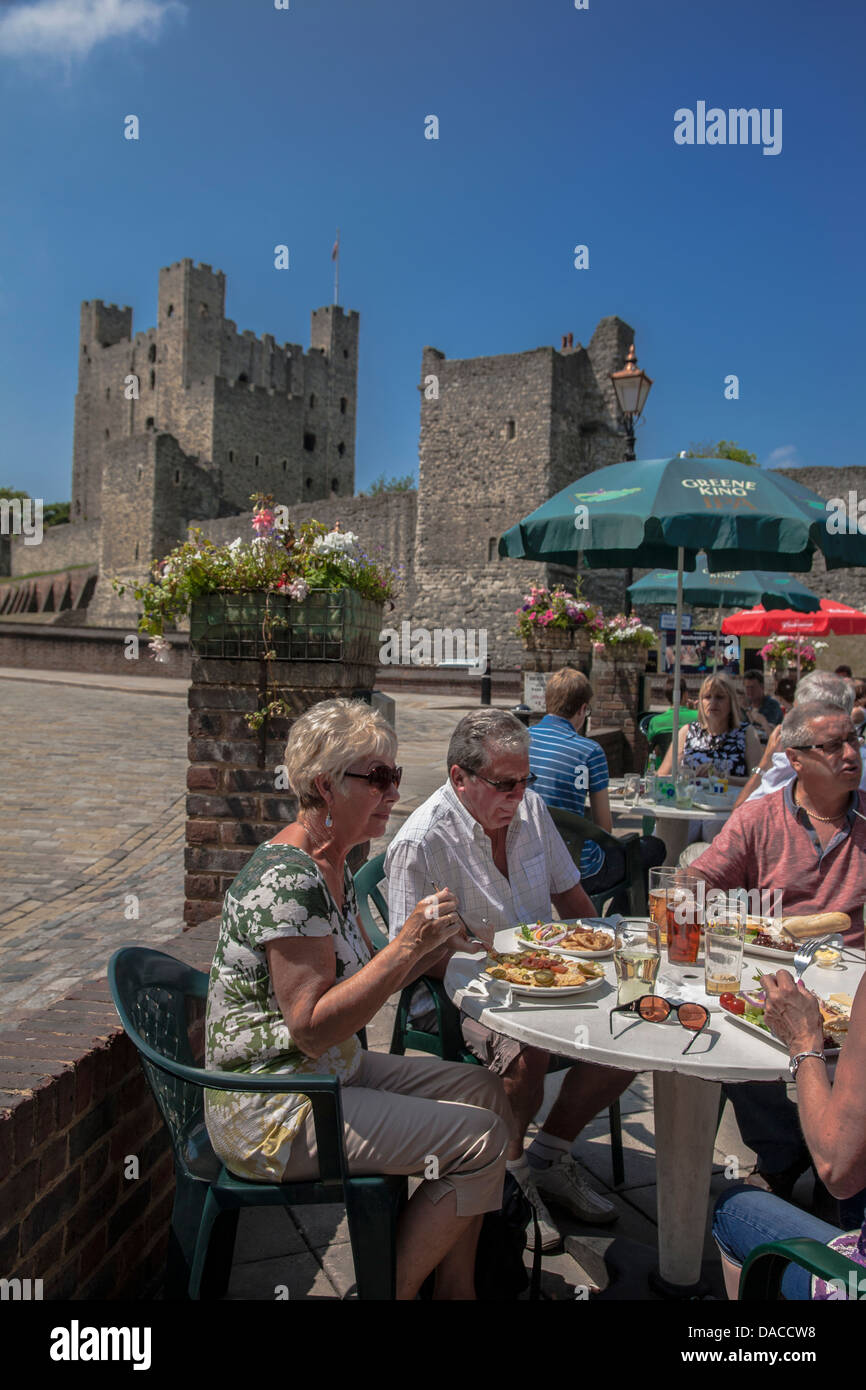 People dining outside Rochester Castle, Rochester, Kent, England, UK, GB Stock Photo