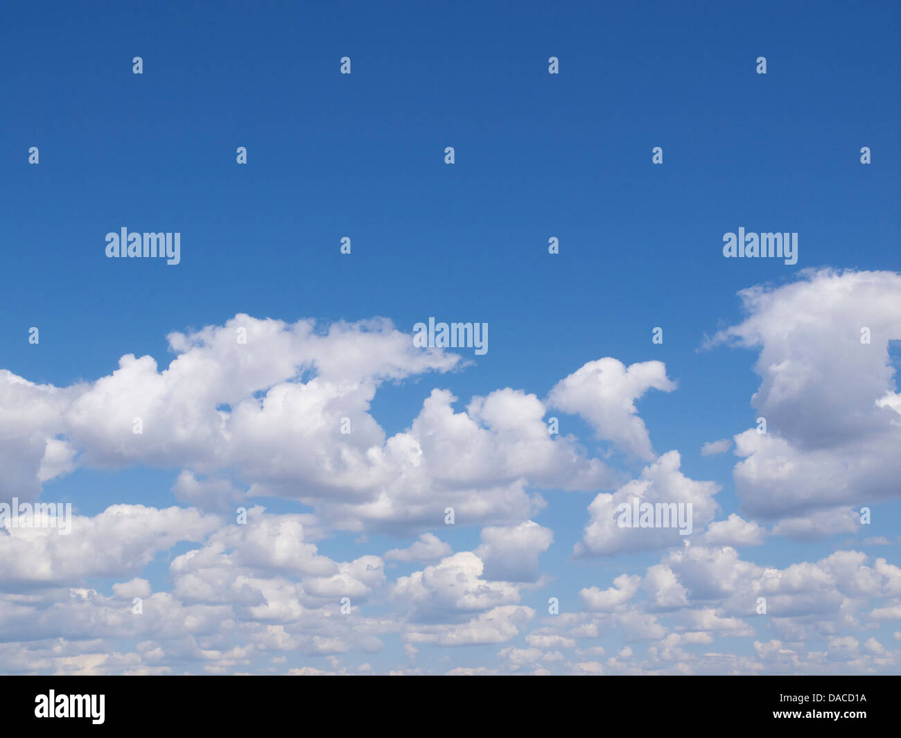 Blue sky with nice clouds in the bottom half of the image photographed in the Algarve, Portugal Stock Photo