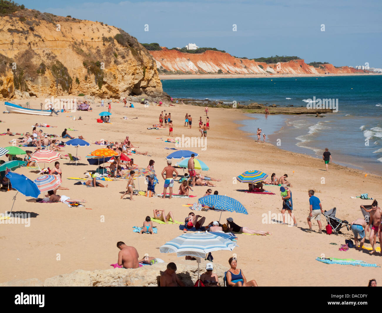 People on a sandy Algarve beach, Olhos d'Agua, Portugal Stock Photo