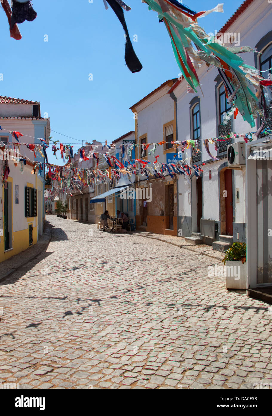 Village street decorated for saints day celebrations in Ferragudo, the Algarve, Portugal Stock Photo