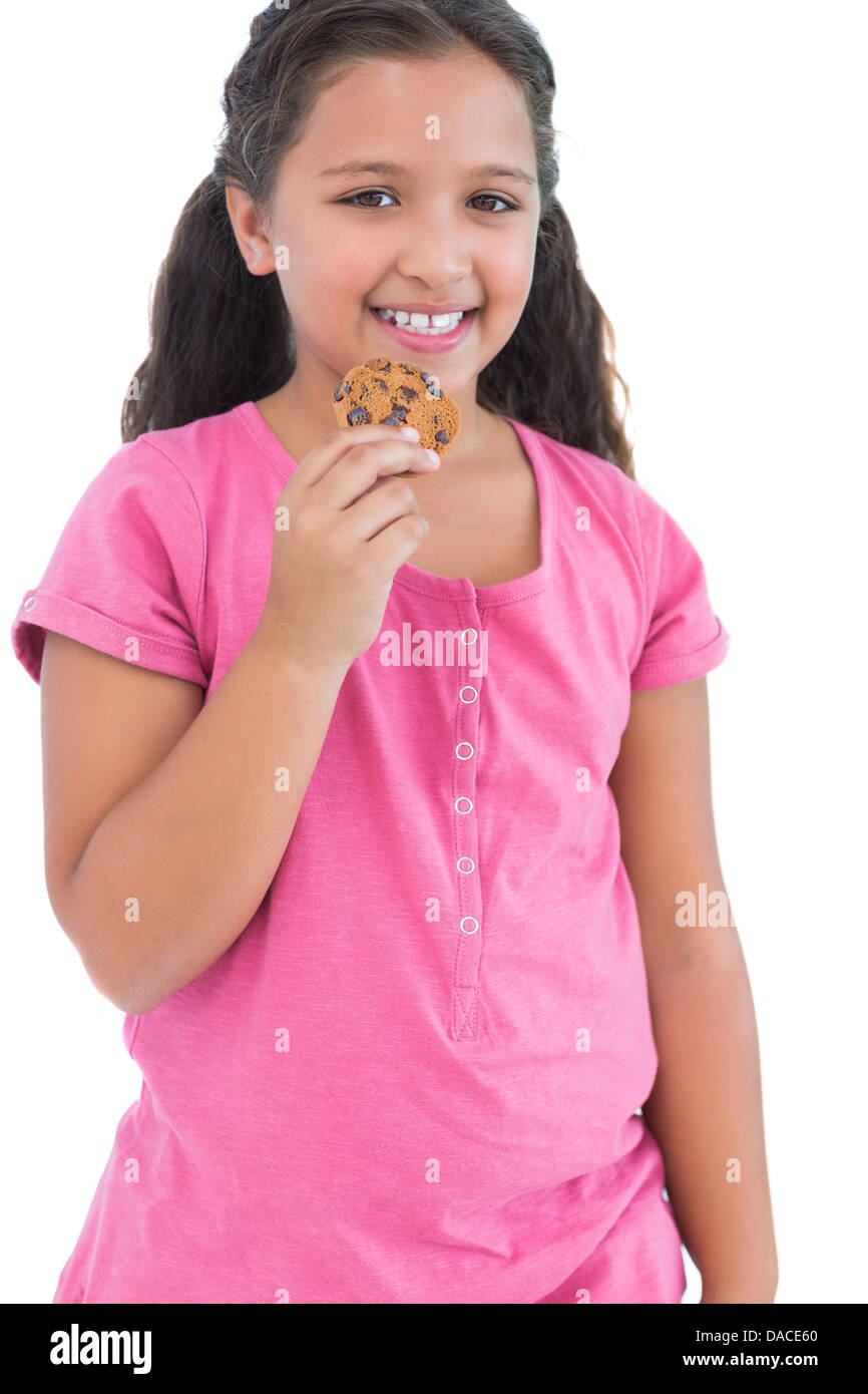Little girl eating a cookie Stock Photo Alamy