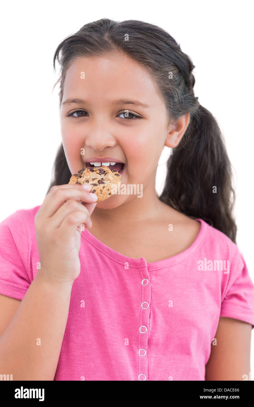 Smiling little girl eating a cookie Stock Photo Alamy