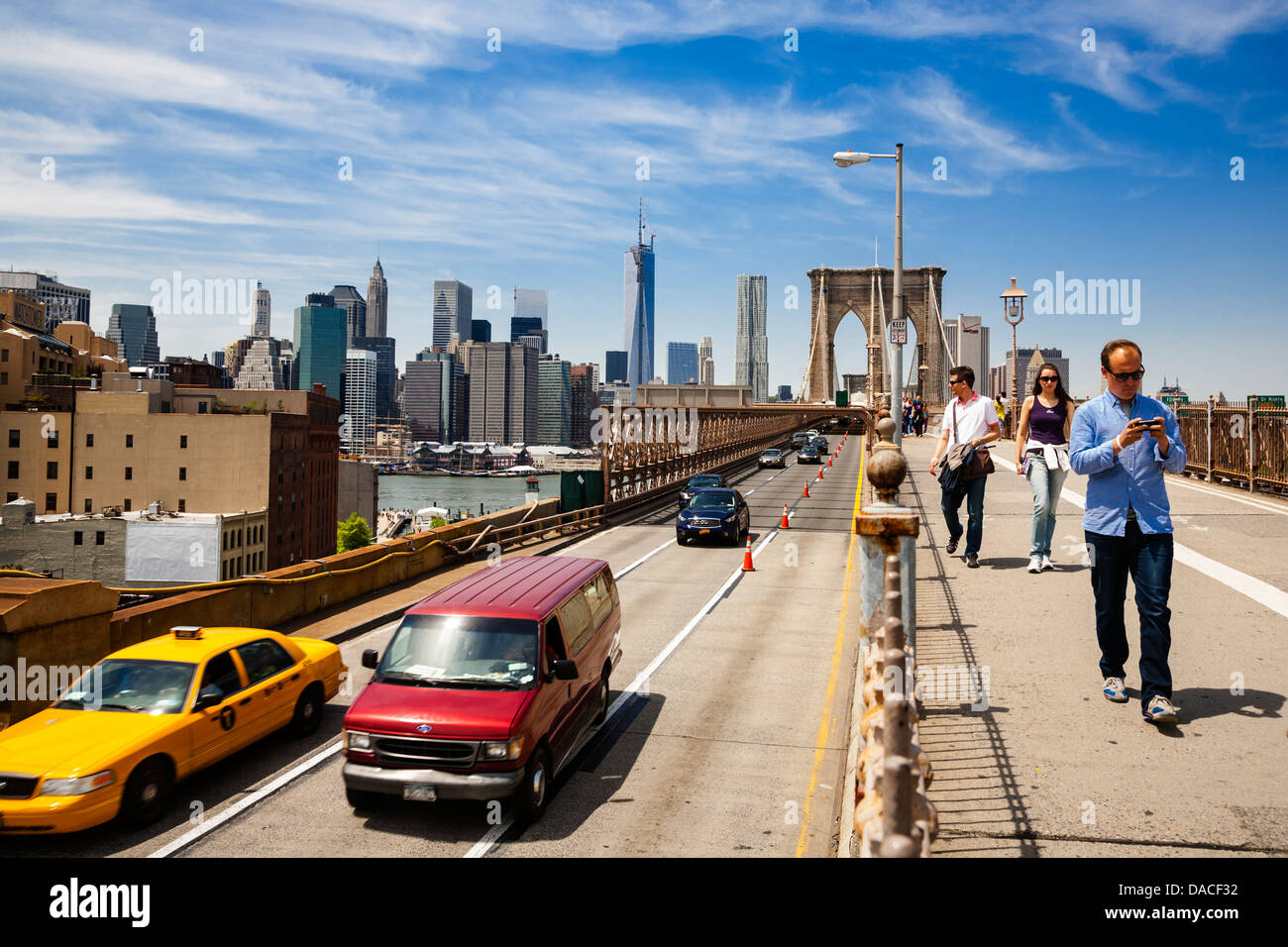 Traffic and pedestrians crossing the Brooklyn Bridge, NYC, USA. Stock Photo