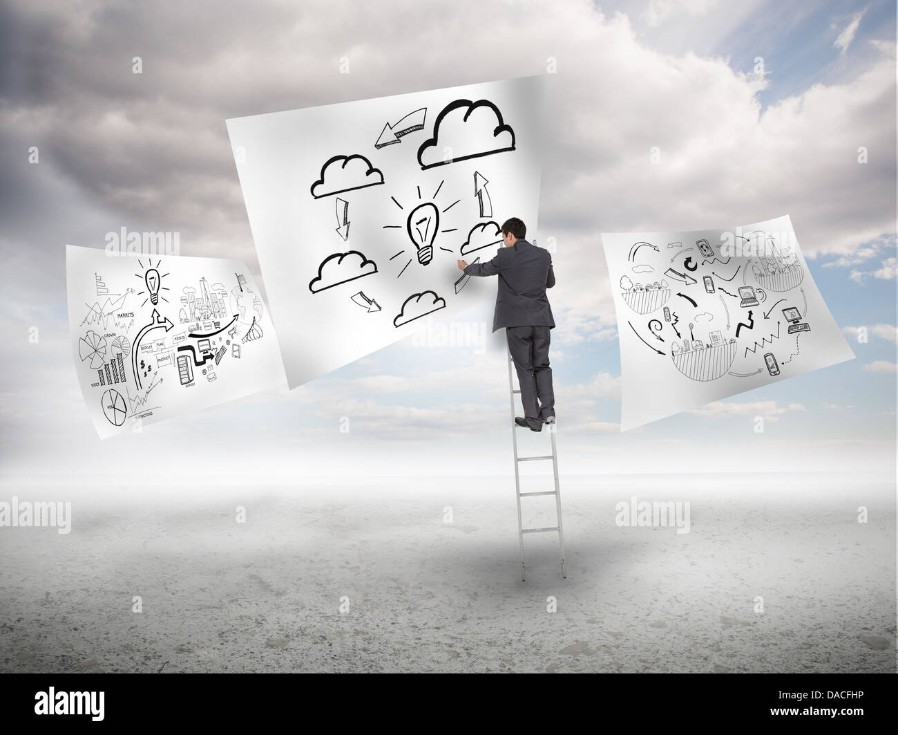 Businessman on a ladder drawing a process Stock Photo