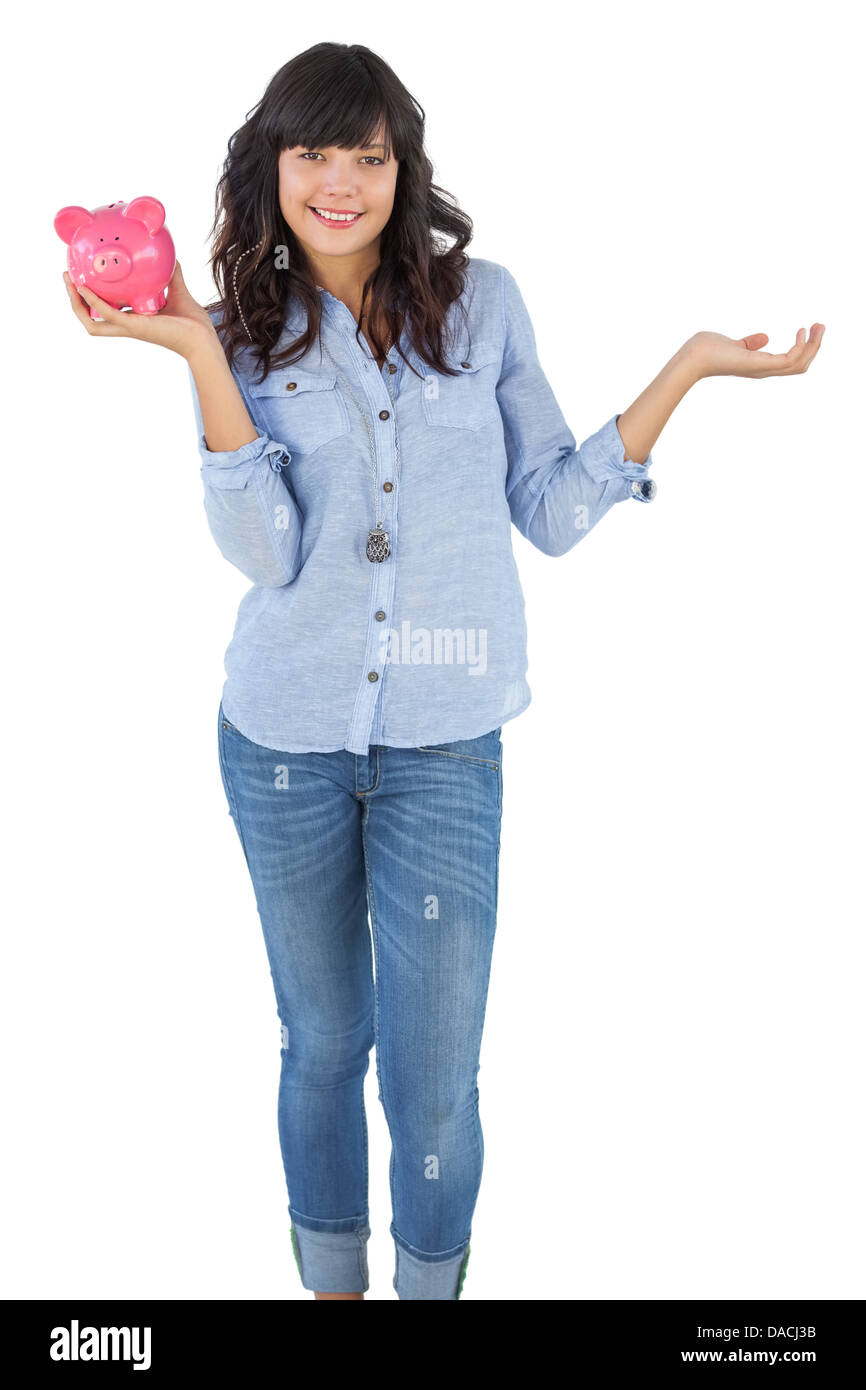 Young woman holding her piggy bank Stock Photo - Alamy