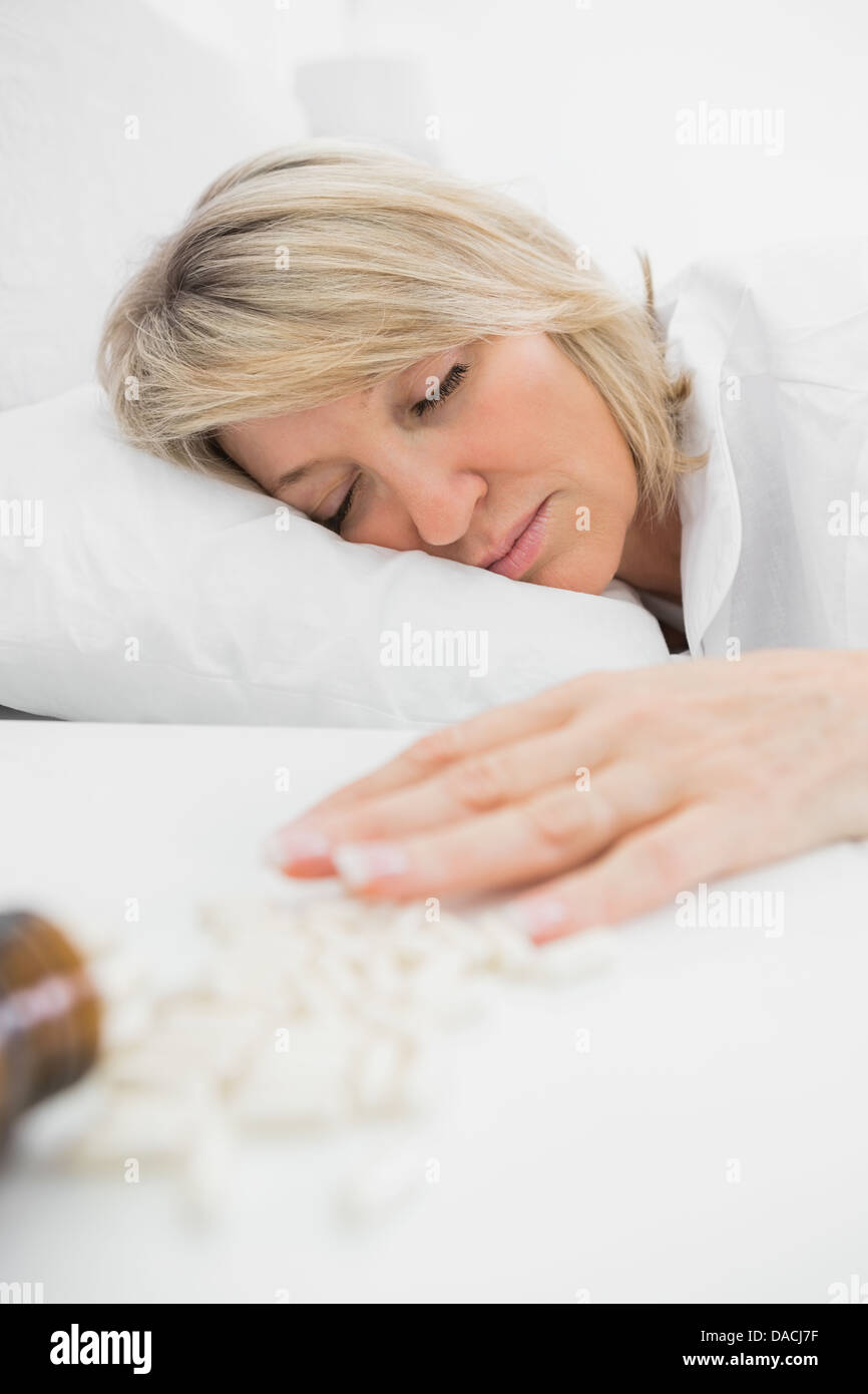 Blonde woman lying motionless after overdose Stock Photo