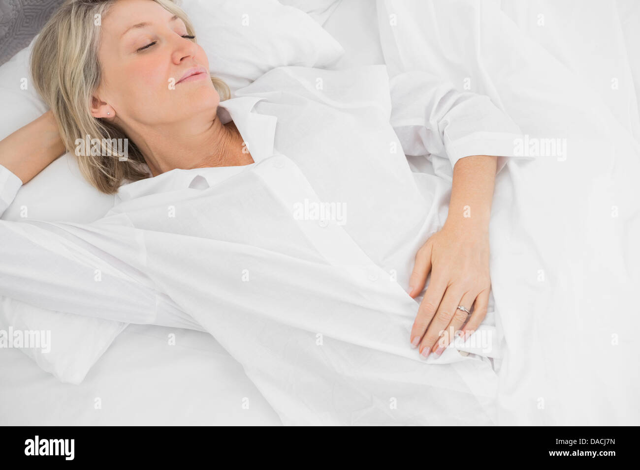 Woman asleep in bed Stock Photo