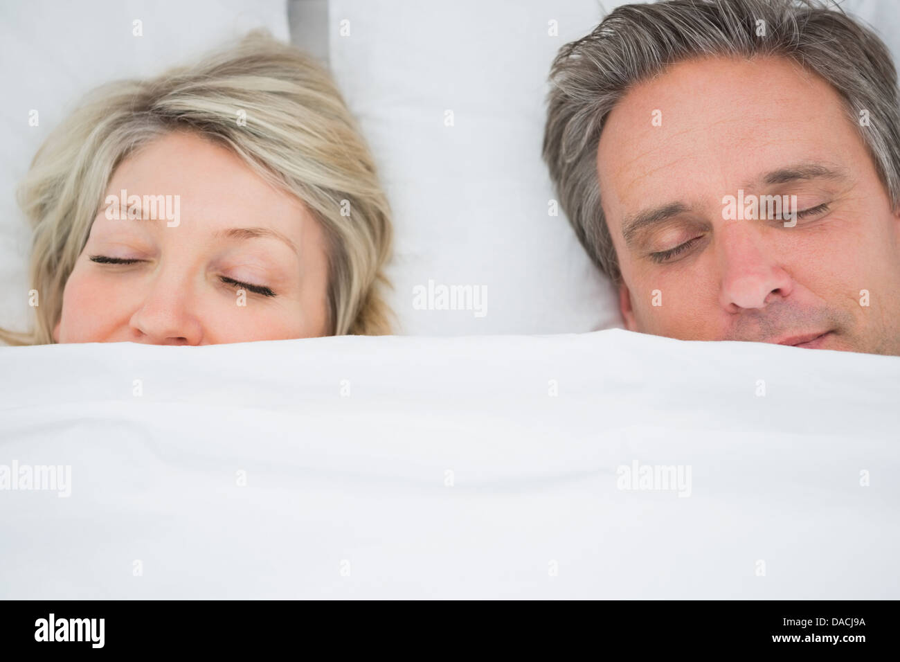 Couple sleeping under the covers Stock Photo Alamy