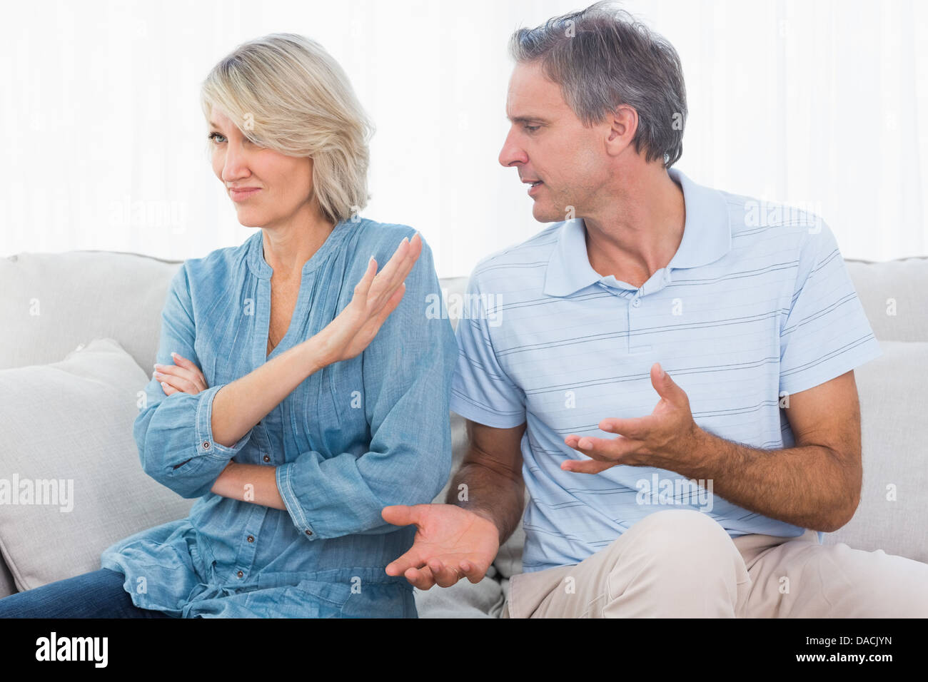 Man pleading with his wife after a fight Stock Photo