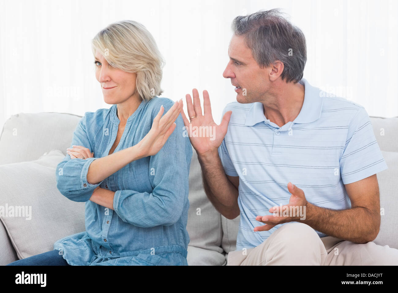 Man pleading with his wife after an argument Stock Photo