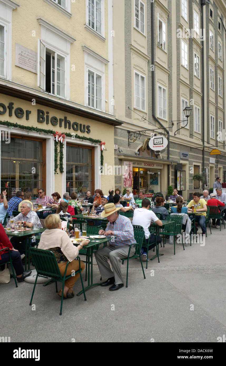 Salzburg, Austria People dining outside at Zipfer Bierhaus on Sigmund-Haffner-Gasse in Salzburg, Austria. Photo May 2013. Stock Photo