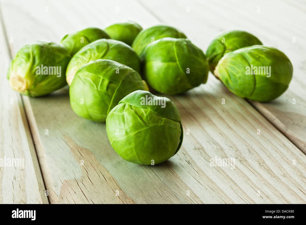 Brussels Sprouts Raw Brussels sprouts on a rustic wood background