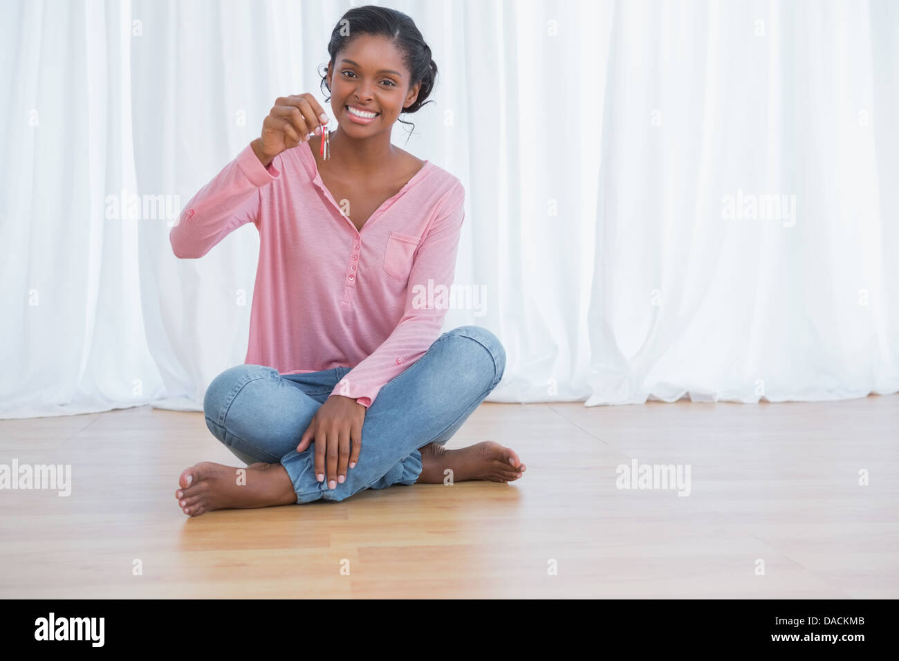 Happy young woman showing her new house keys Stock Photo - Alamy