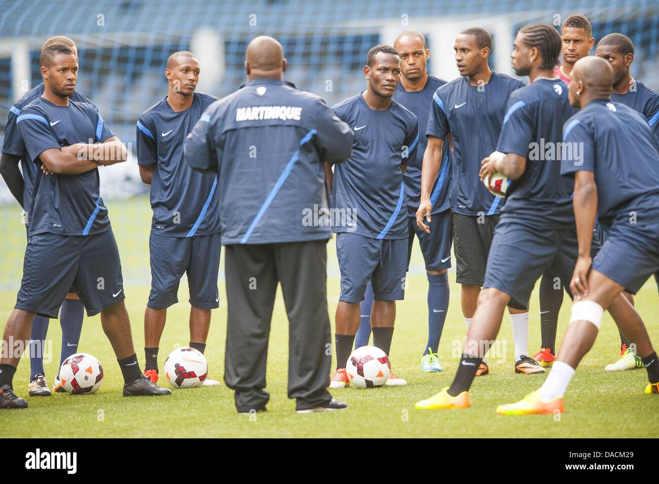 Seattle, Washington, USA. 10th July, 2013. Coach Patrick Cavelan, the National Team coach of Martinique talks with his men at a relaxed workout at Seattle's CenturyLink field readying for their upcoming Gold Cup match against Panama. Martinique is coming off a surprise win against the Canada National Team in CONCACAF play. Held every two years, the CONCACAF Gold Cup is the main association football competition of the men's national football teams governed by CONCACAF, determining the regional champion of North America, Central America, and the Caribbean. Stock Photo