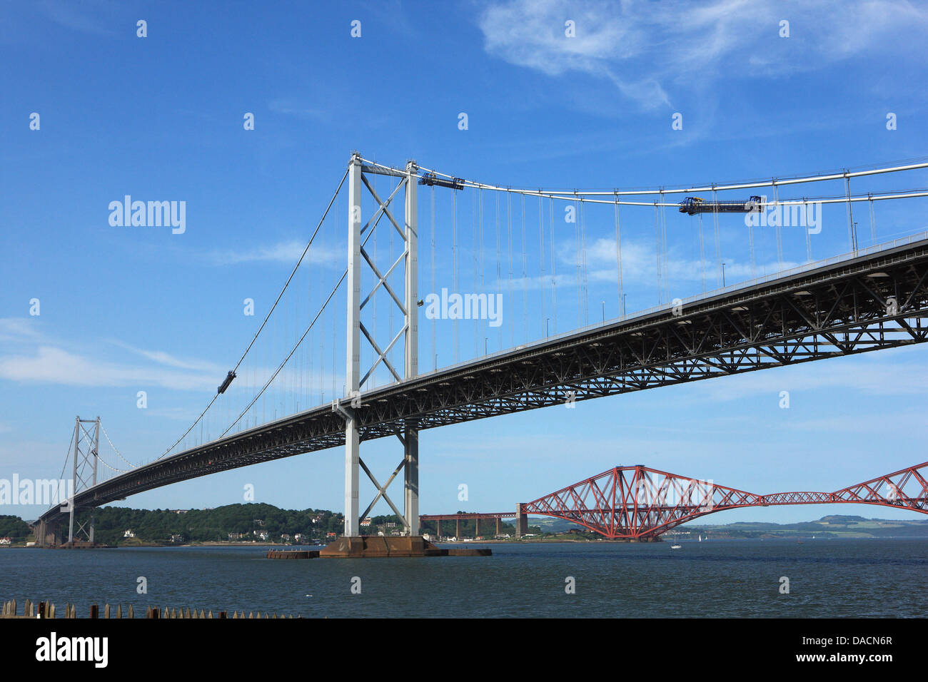 The Forth Rail Bridge seen below the Forth Road Bridge spanning the Firth of Forth from South to North Queensferry in Scotland Stock Photo