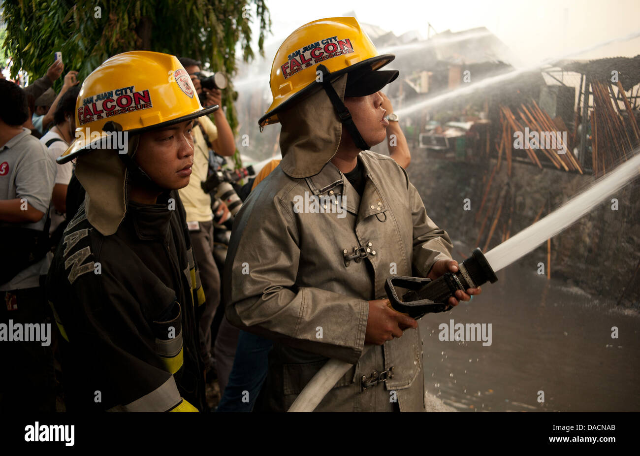 Water And Fire Streaming En Français Firemen hose down a fire in a shanty town in Makati City, Metro Stock