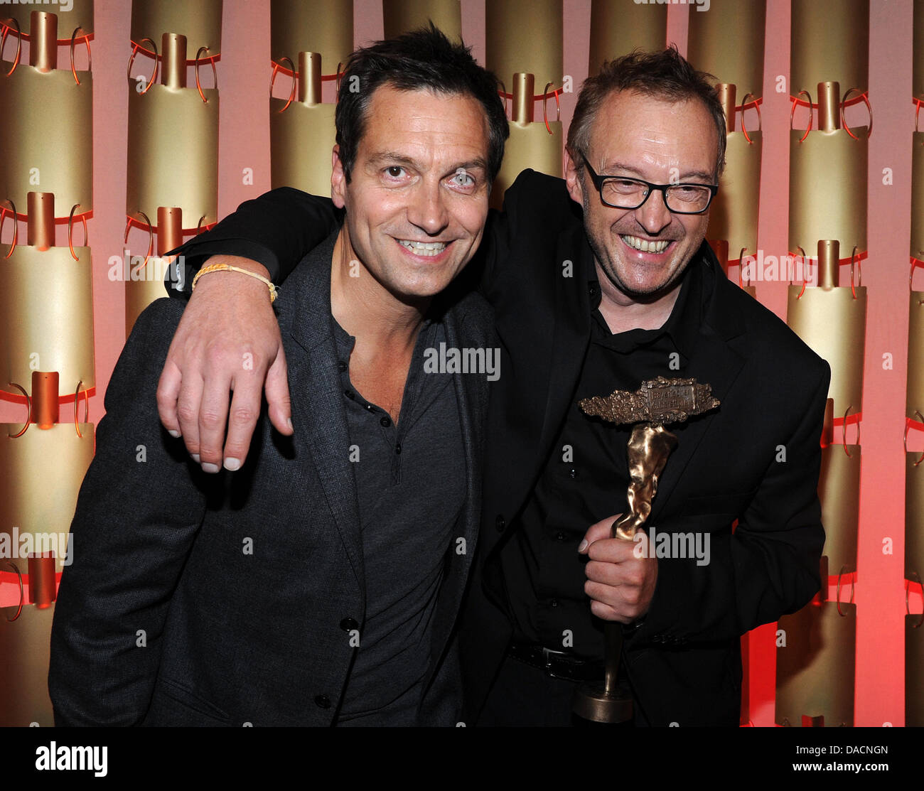 Austrian cabaret actor Josef Hader (r) and his laudator Dieter Nuhr cheer after receiving the main prize at the Bavarian Cabaret Prize awards in Munich, Germany, 27 September 2011. Since 1999, the prize is anually awarded to artists from German-speaking countries in four different categories. The ceremony will be broadcasted on Bavarian Television TV channel on 7 October at 22:30.  Stock Photo