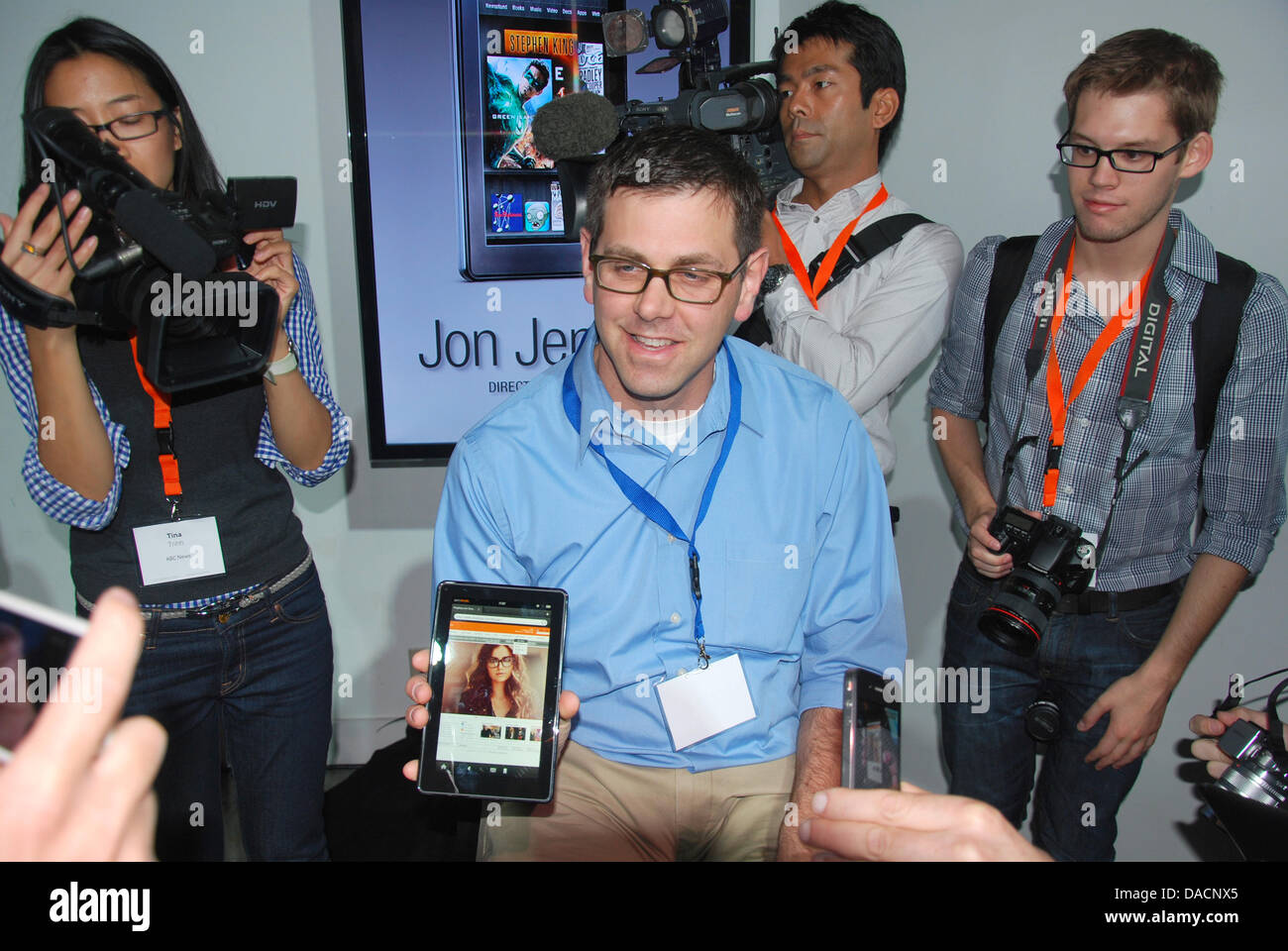 Amazon developer Jon Jenkins (C) shows journalists the new 'Kindle Fire' in New York, New York, USA, 28 September 2011. The device will initially cost 199 dollars in the USA and is to compete with the twice as expensive iPad from apple. Sales begin on 15 November. The Amazon tablet will give the iPad heavy competition, because the online dealer, like Apple, has a broad palet of con Stock Photo