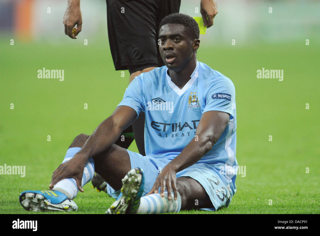 Manchester's Kolo Toure sits on the pitch during the Champions League