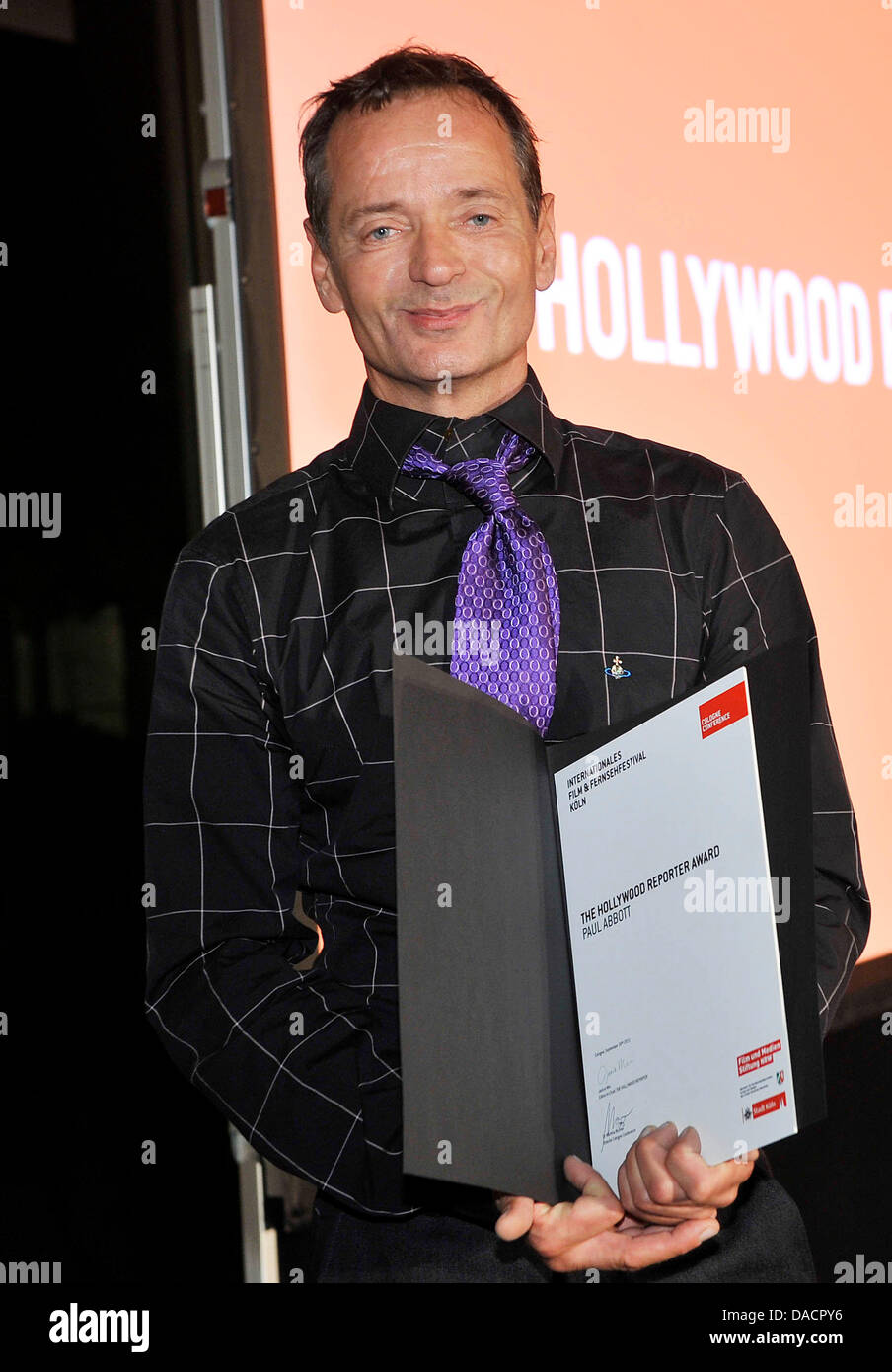 Writer  Paul Abbott, honoured with the 'Hollywood Reporter Awards', poses during the awarding at the end of the 'Cologne Conference 2011' in Cologne, Germany, 30 September 2011. On the last day of the film and television festival, the 'German Casting Prize 2011', the 'Hollywood Reporter Award', the 'TV Spielfilm Prize' and the 'Film prize Cologne' was awarded. Photo: Henning Kaiser Stock Photo