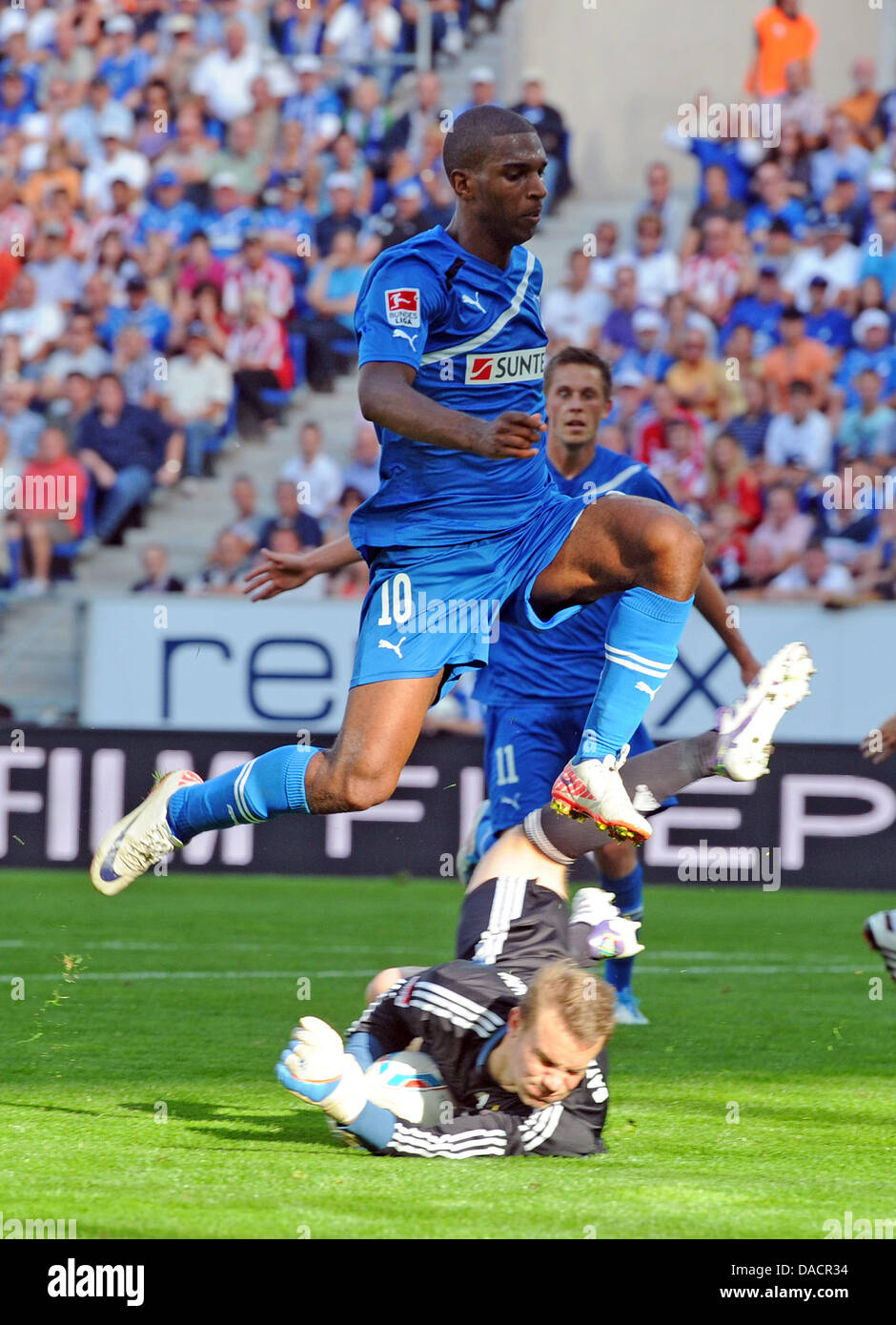 Munich's goalkeeper Manuel Neuer (BELOW) saves the ball before Hoffenheim's Ryan Babel during the German Bundesliga soccer match between TSG 1899 Hoffenheim and FC Bayern Munich at Rhein-Neckar-Arena in Sinsheim, Germany, 01 October 2011. Photo: ULI DECK        (ATTENTION: EMBARGO CONDITIONS! The DFL permits the further  utilisation of the pictures in IPTV, mobile services and othe Stock Photo