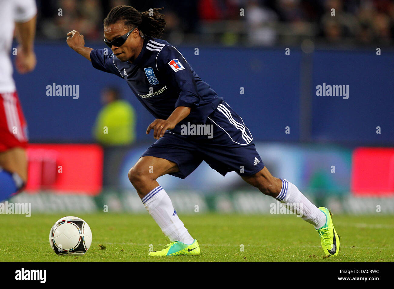 Edgar Davids of 'Team Ronaldo, Zidane and friends' runs with the ball during the charity soccer match against poverty between 'Team Ronaldo, Zidane and friends' and 'HSV Allstars ' at Imtech Arena in Hamburg, Germany, 13 December 2011. Photo: Malte Christians dpa/lno Stock Photo