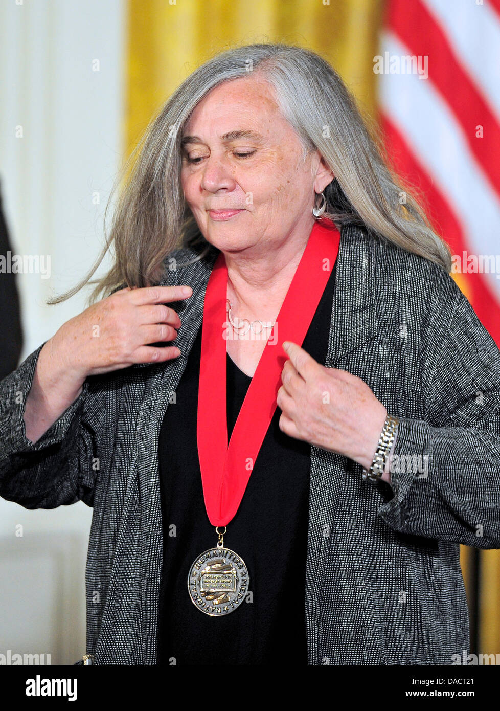 Novelist Marilynne Robinson returns to her seat after accepting the