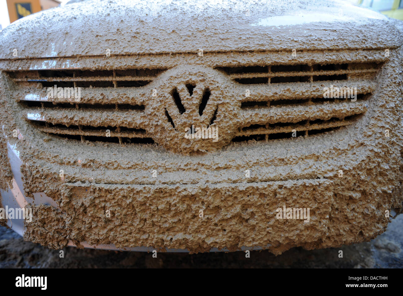 The emblem of a VW Tiguan is almost completely covered in mud at a  construction site in Calden near Kassel, Germany, 15 December 2011. Weather  in the coming days wil be dominated