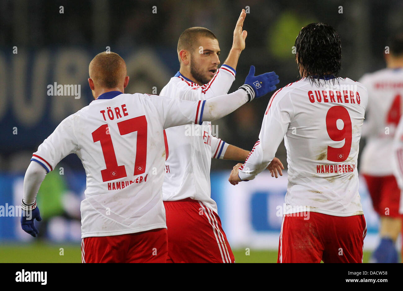 Hamburg's Gokhan Tore (L-R), Mladen Petric and goal scorer Paolo Guerrero  celebrate the 1-1 goal during the German Bundesliga match between Hamburger  SV and FC Augsburg at Imtech Arena in Hamburg, Germany,