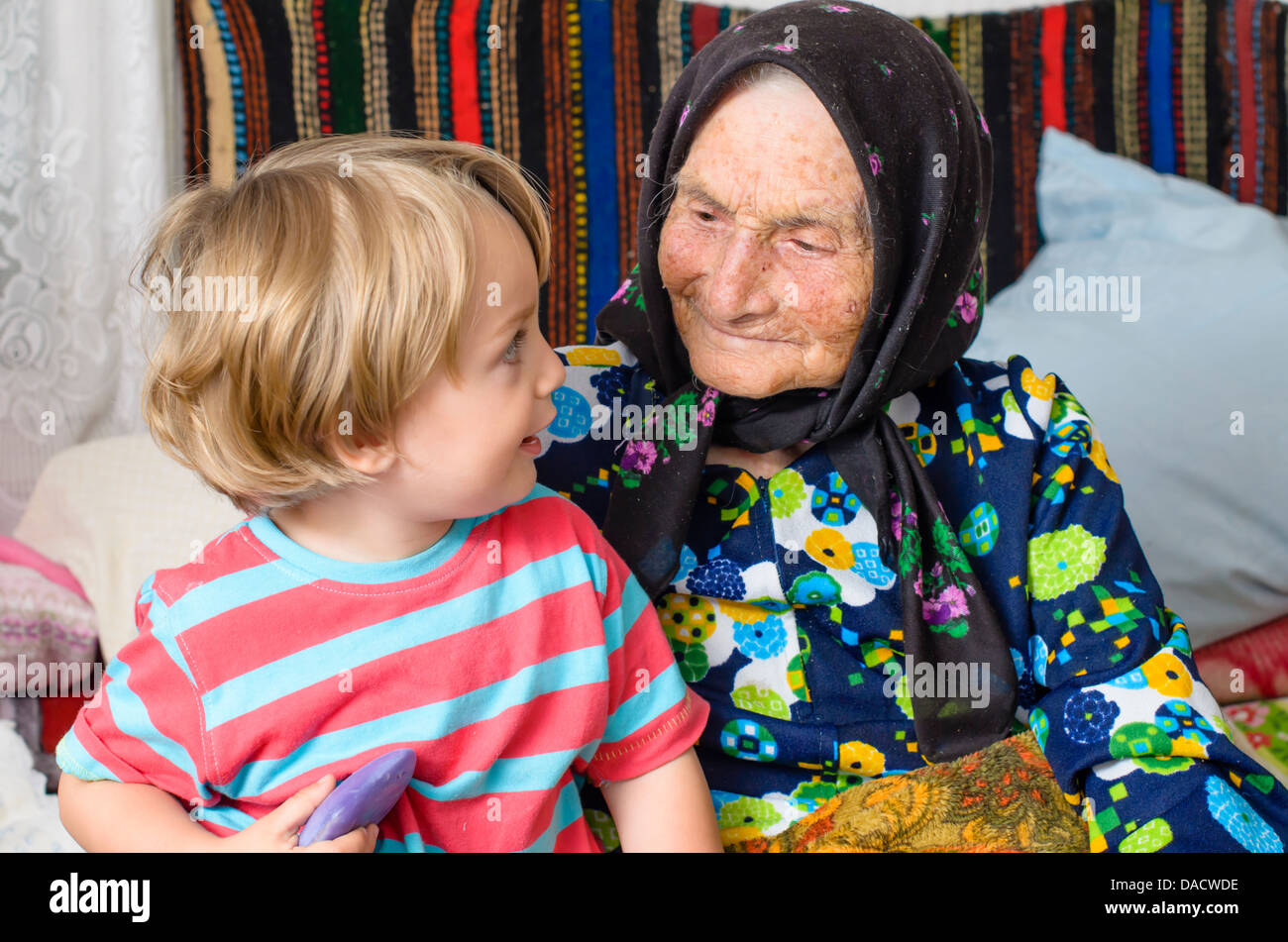 Great grandmother and her great grandson in a rustic home Stock Photo